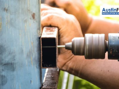 fence contractor repairing a metal fence
